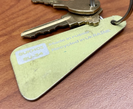 Own a piece of history with Mad Bomber's Yellow Keychain – crafted from genuine TITANIUM skin of a downed Russian Su-34 Fighter Jet near Kyiv, Ukraine. Handcrafted and collectible, support Ukraine with style.
